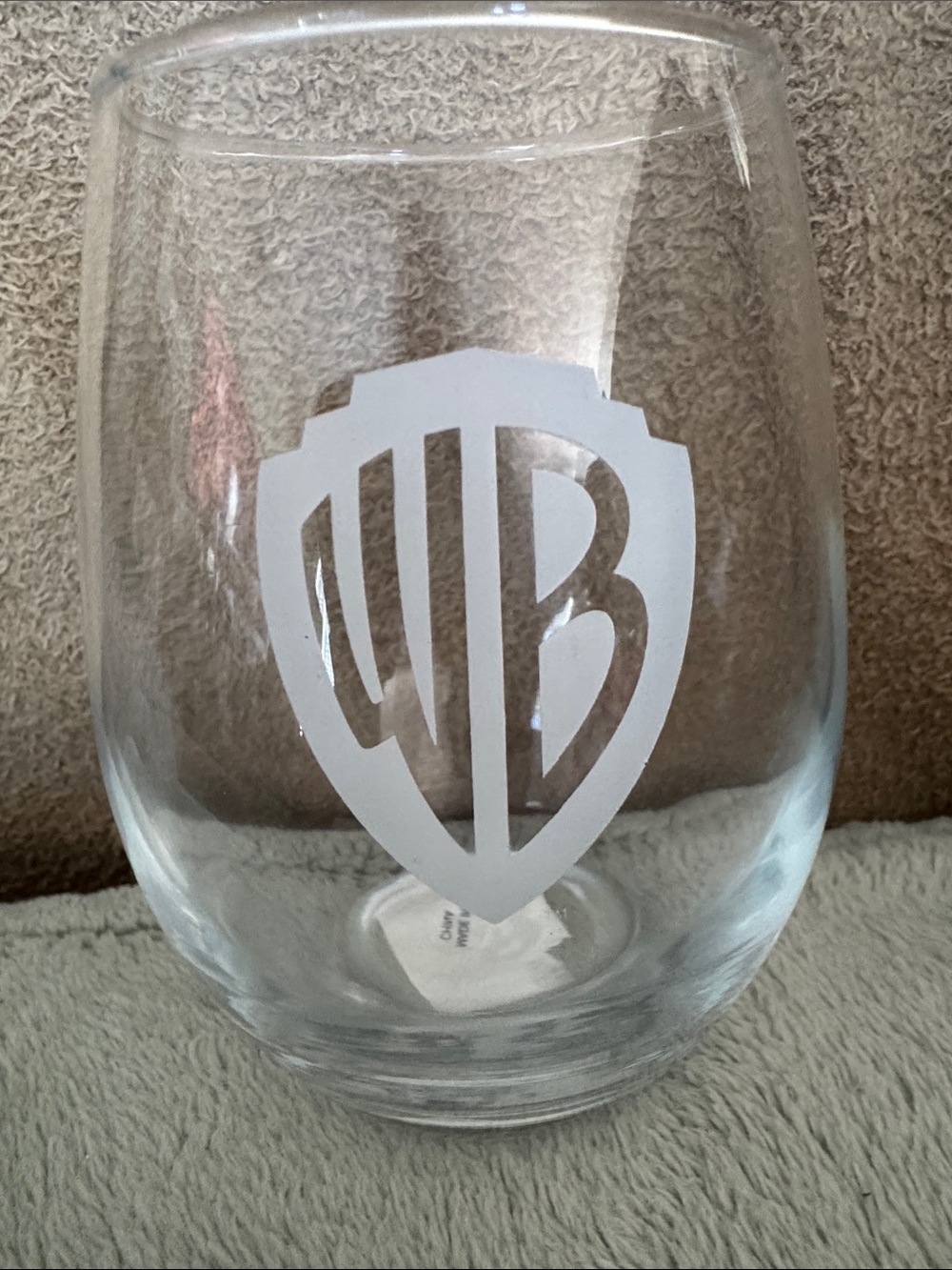 Warner Bros. Clear Stemless Wine Glass with White Etched WB Shield, new